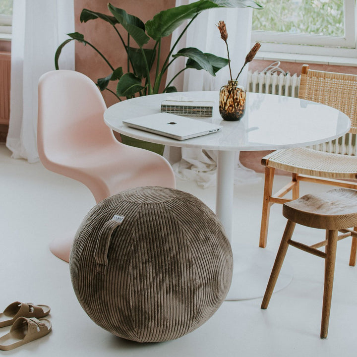 VLUV Sitzball BOL VLIP Nougatbraun mit Griff und Breitcordbezug am runden Tisch